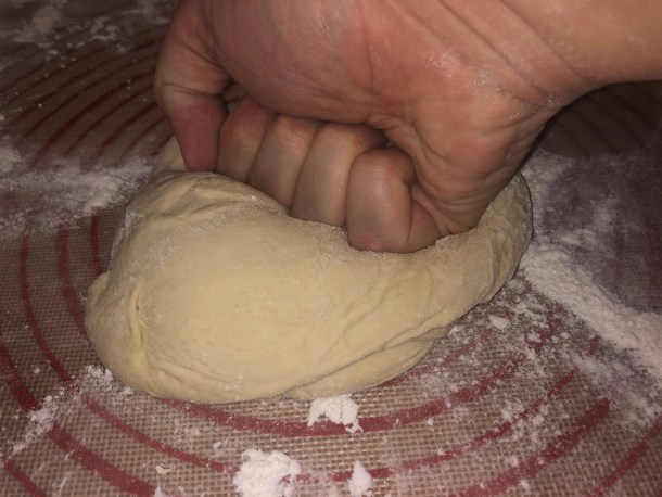 Cooking Eorzea | Punching down a dough ball.