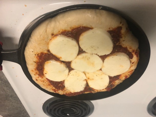 Cooking Eorzea | Baking the bottom of the pizza on stovetop.